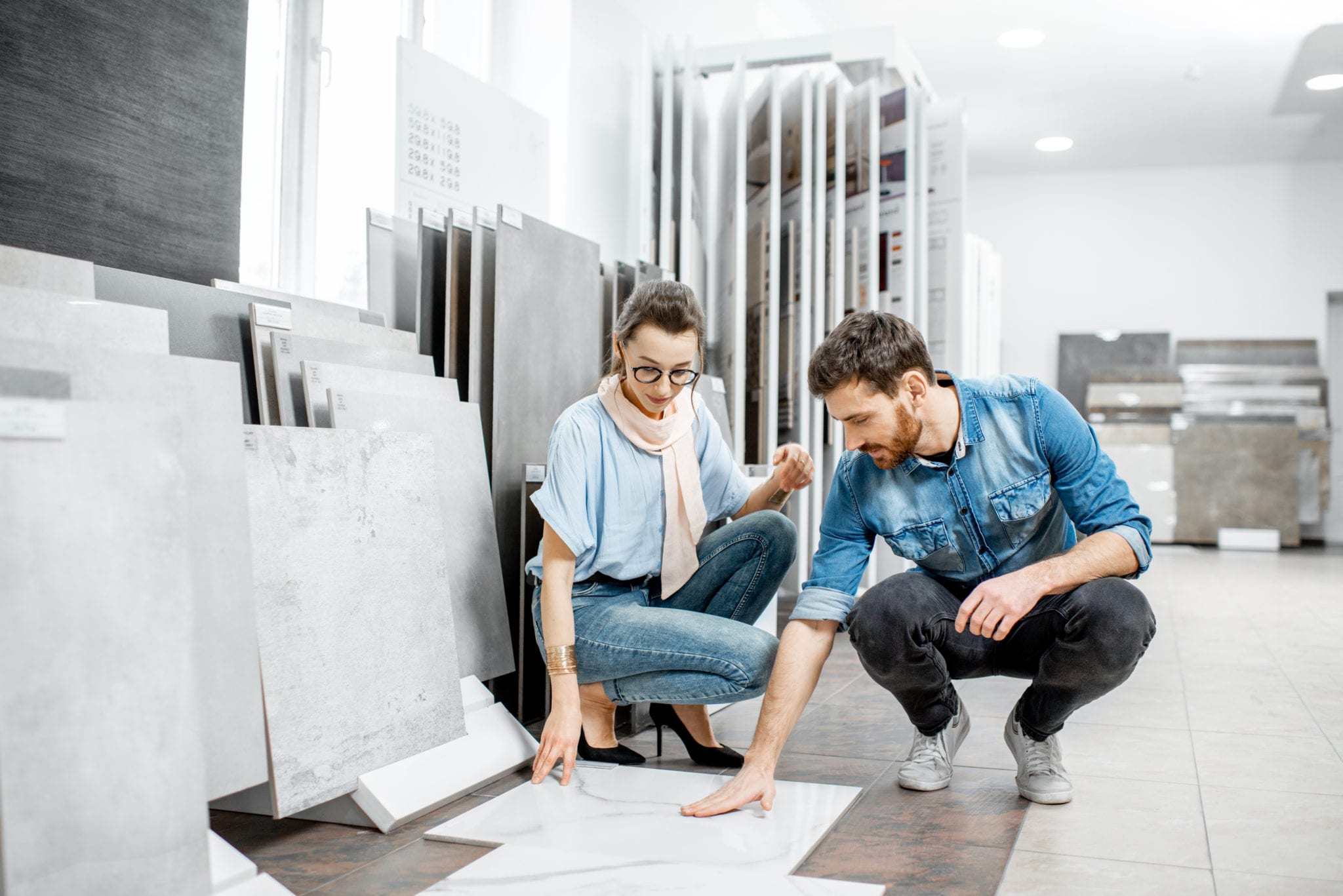 Couple consulting which tile to choose in a shop.